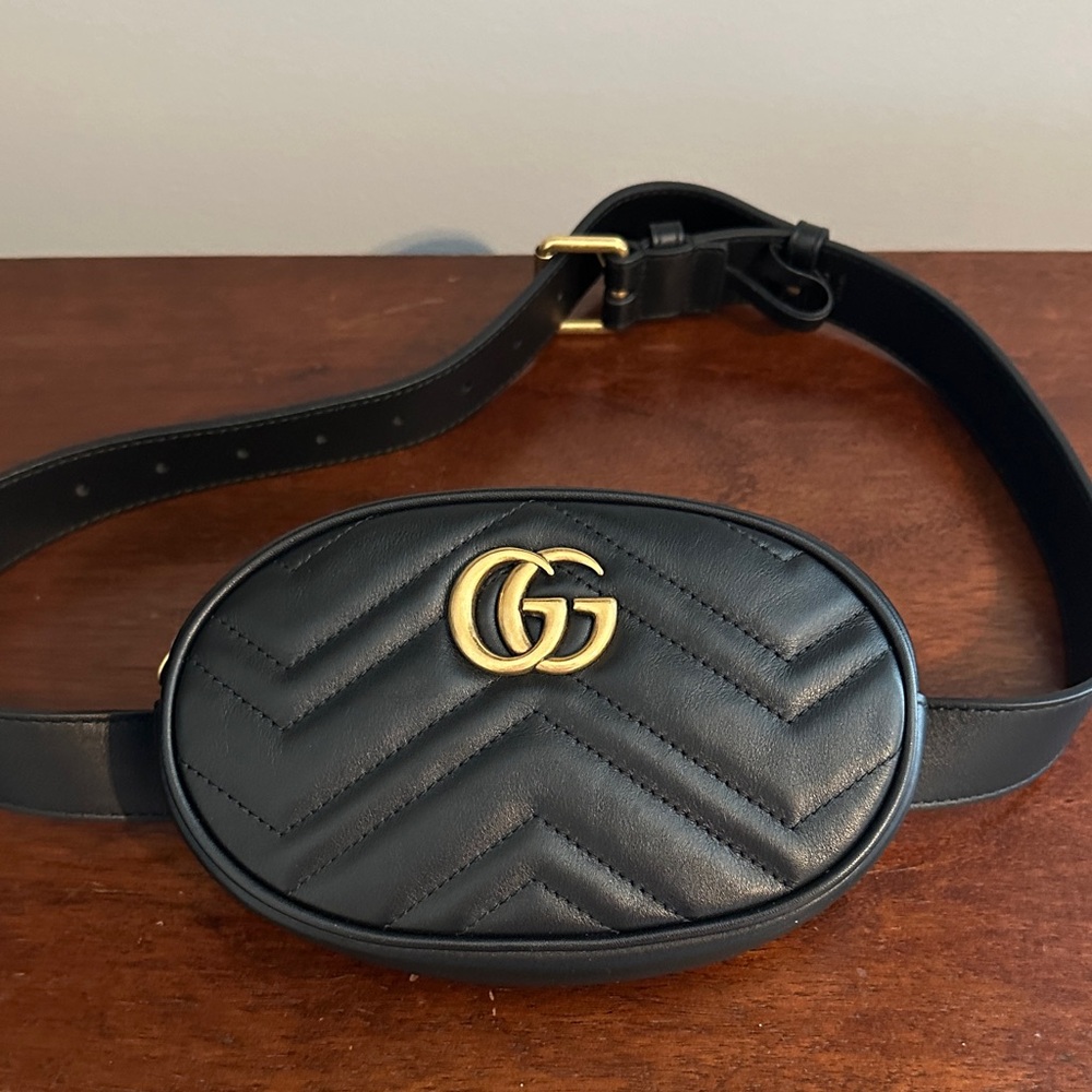 Gucci Marmont, black leather belt bag with gold hardware.